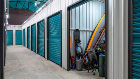 storage facility with an open storage unit displaying outdoor recreational items